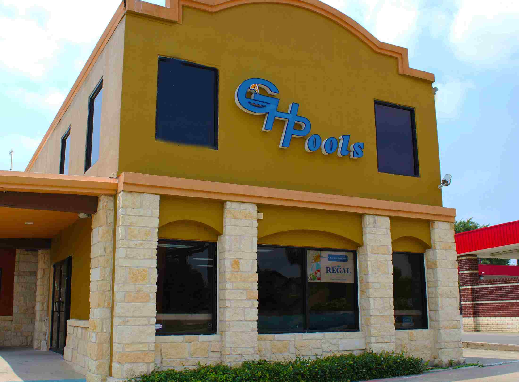 The picture of building with the logo of G.H. Pools